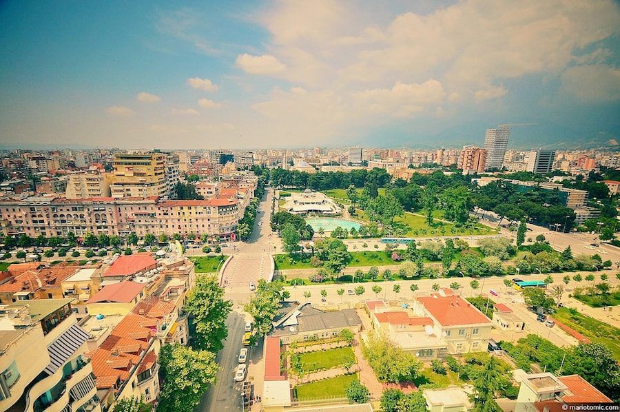 A panoramic view of Tirana, showcasing the cityscape from atop a building.