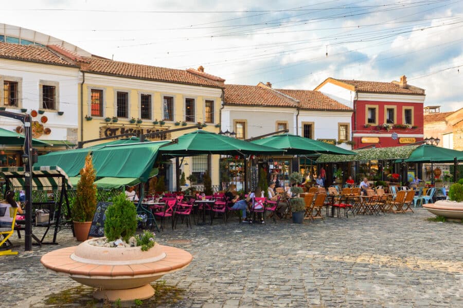 People enjoying summer evening at cafes in Korce (Korca) city in